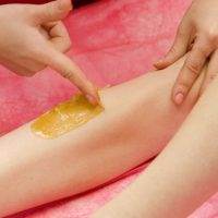 a young woman getting her leg sugared (hair removal) at intermezzo salon and spa in seattle